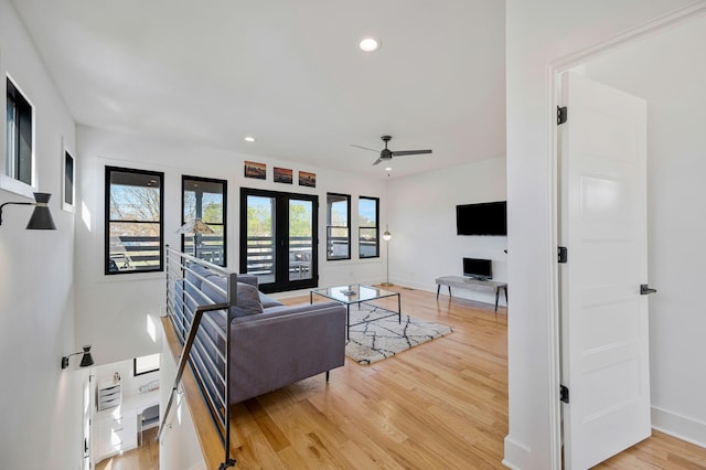 living room featuring light wood finished floors, baseboards, a ceiling fan, and recessed lighting