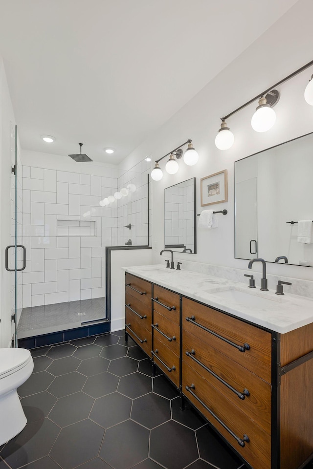 bathroom with a stall shower, tile patterned floors, toilet, double vanity, and recessed lighting