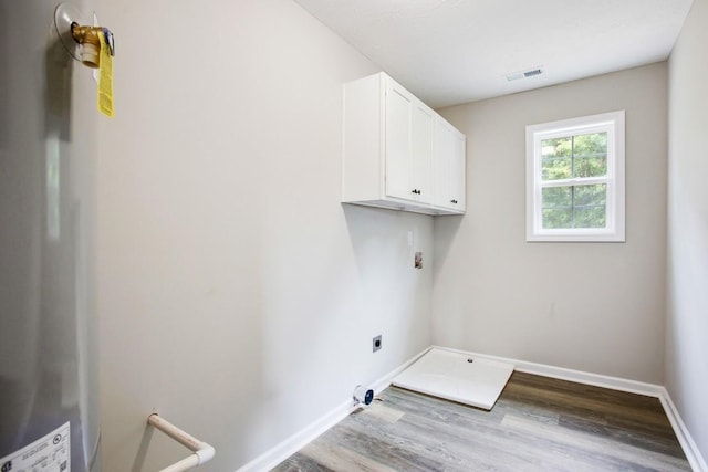 1212 Hollis Ln, Lafayette, TN 37083 - laundry room featuring visible vents, baseboards, wood finished floors, cabinet space, and electric dryer hookup