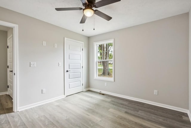 1212 Hollis Ln, Lafayette, TN 37083 - empty room with wood finished floors, visible vents, baseboards, and ceiling fan