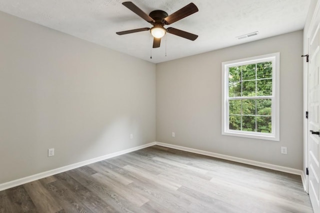 1212 Hollis Ln, Lafayette, TN 37083 - empty room featuring ceiling fan, baseboards, wood finished floors, and visible vents
