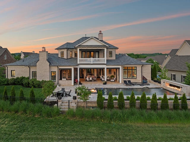 6302 Wild Heron Way, College Grove, TN 37046 - rear view of property with an outdoor living space with a fire pit, a fenced backyard, a chimney, a patio area, and a balcony