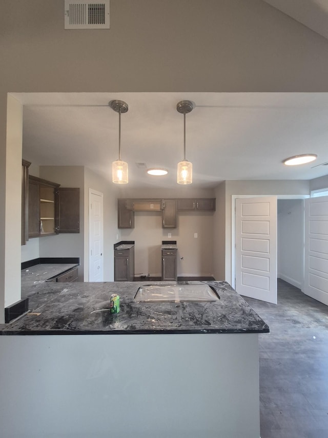 5 Hugh Hunter Rd, Oak Grove, KY 42262 - kitchen featuring a peninsula, stovetop, pendant lighting, dark stone counters, and concrete floors
