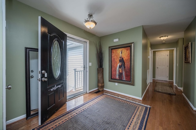 entrance foyer with wood finished floors and baseboards