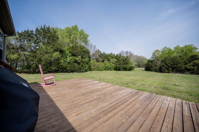 wooden terrace with a lawn