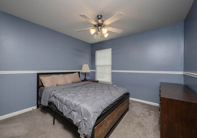 carpeted bedroom featuring baseboards and a ceiling fan