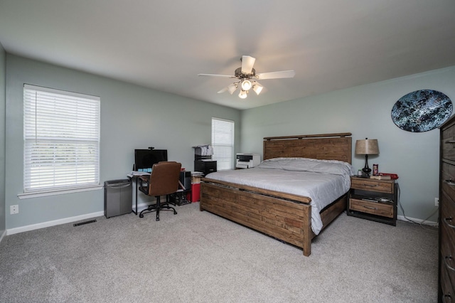 bedroom featuring visible vents, baseboards, a ceiling fan, and carpet flooring