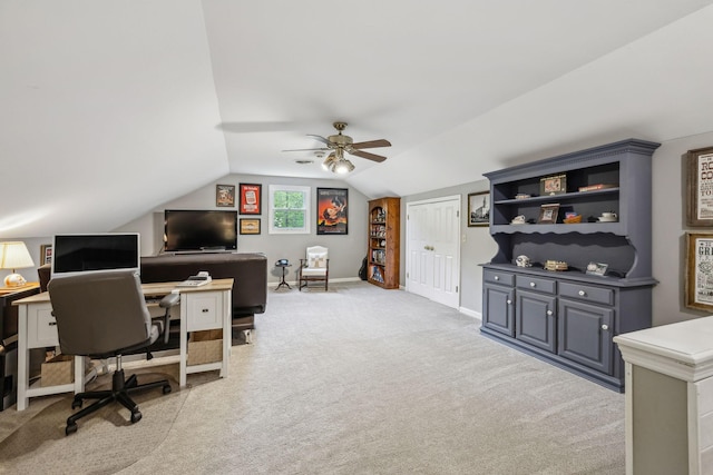 carpeted office with lofted ceiling, baseboards, and ceiling fan