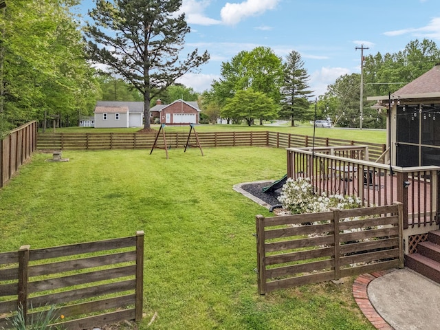 view of yard featuring a fenced backyard, a wooden deck, and a sunroom