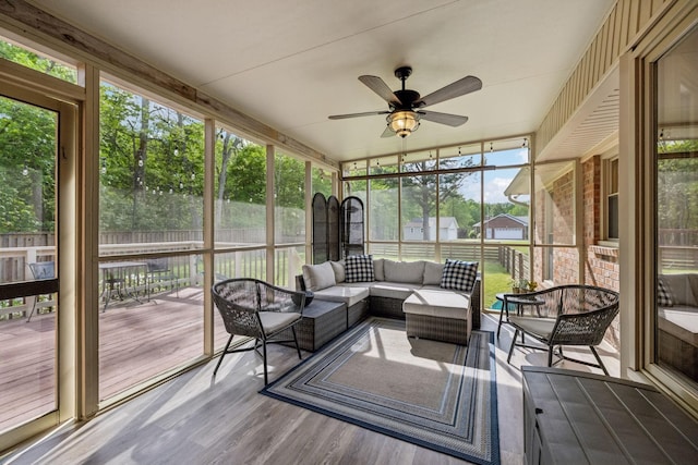 sunroom / solarium with ceiling fan and outdoor lounge area