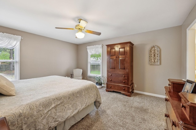 bedroom with light carpet, a ceiling fan, and baseboards