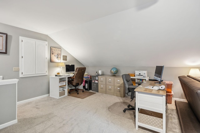 carpeted home office with lofted ceiling and baseboards