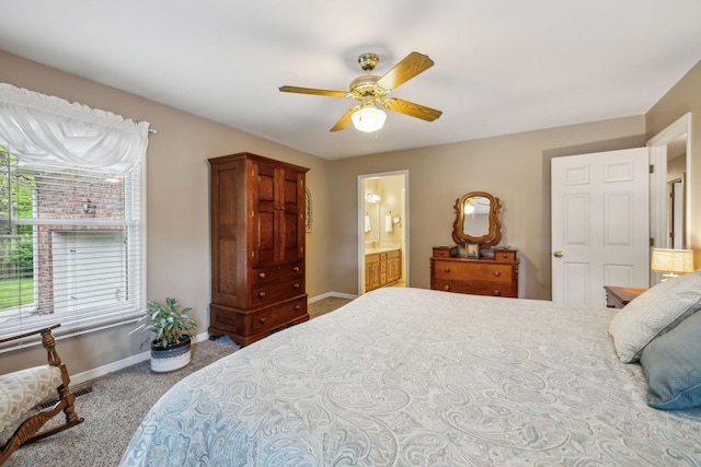 carpeted bedroom with baseboards, ceiling fan, and ensuite bathroom