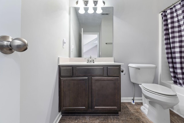 bathroom featuring toilet, baseboards, visible vents, shower / tub combo, and vanity