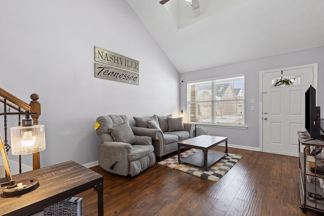 living area featuring high vaulted ceiling, stairway, ceiling fan, baseboards, and dark wood-style floors