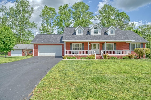 cape cod house with aphalt driveway, a front lawn, an attached garage, covered porch, and brick siding