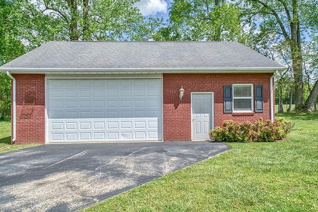 view of front of home with brick siding, a front yard, a garage, and aphalt driveway