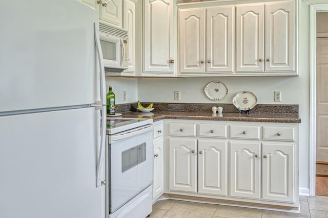 kitchen featuring white cabinets, white appliances, and light tile patterned floors