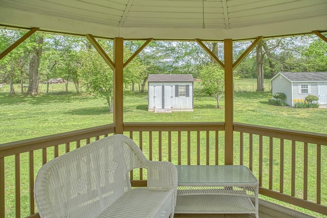 exterior space featuring a lawn, an outbuilding, and a storage unit