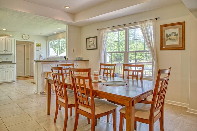 dining room featuring a wealth of natural light, light tile patterned flooring, and recessed lighting