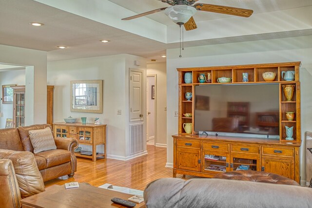 living room with a ceiling fan, baseboards, recessed lighting, and light wood-style floors