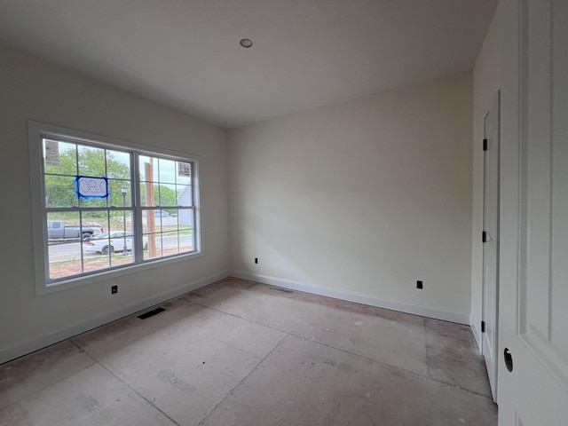 unfurnished room featuring visible vents and baseboards
