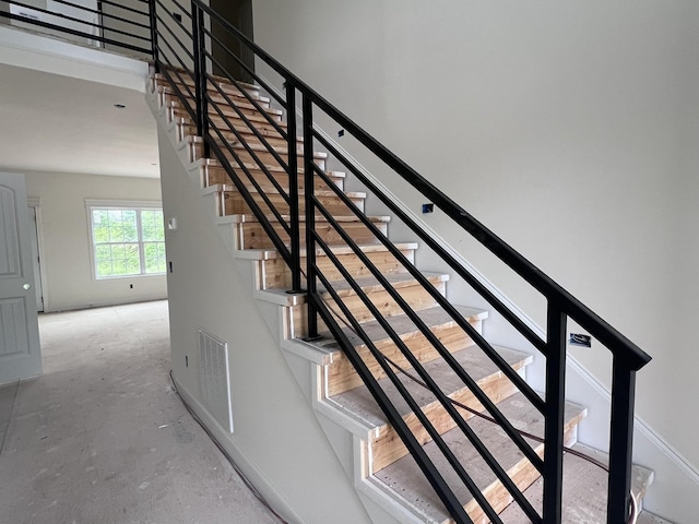 stairs with concrete floors and visible vents
