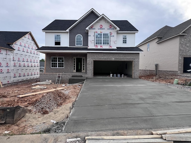 view of front of home with concrete driveway, brick siding, covered porch, and a garage