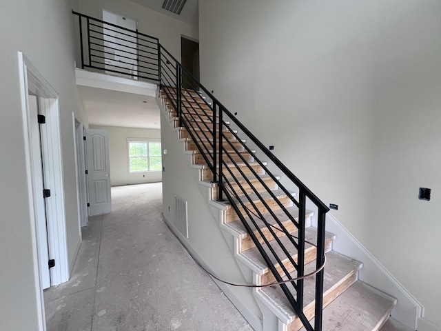 stairway with unfinished concrete floors