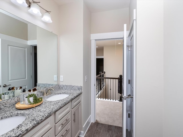 1068 Amelia Park Dr, Franklin, TN 37067 - bathroom featuring double vanity, wood finished floors, baseboards, and a sink