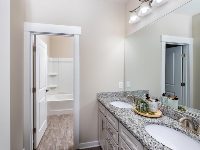 1068 Amelia Park Dr, Franklin, TN 37067 - bathroom featuring baseboards, wood finished floors, a sink, and double vanity