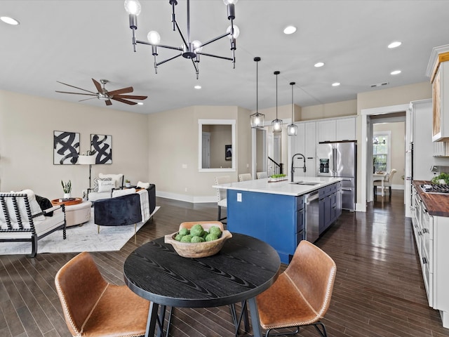 1068 Amelia Park Dr, Franklin, TN 37067 - dining area with ceiling fan with notable chandelier, baseboards, recessed lighting, and dark wood-style flooring