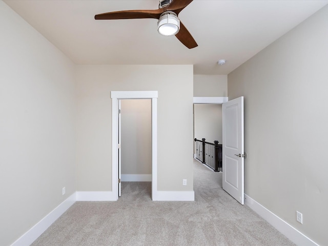 1068 Amelia Park Dr, Franklin, TN 37067 - unfurnished bedroom with light carpet, a ceiling fan, baseboards, and a spacious closet