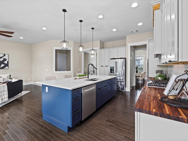1068 Amelia Park Dr, Franklin, TN 37067 - kitchen featuring a sink, white cabinets, appliances with stainless steel finishes, blue cabinetry, and dark wood-style flooring