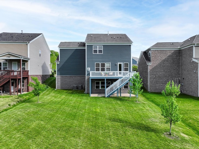 1068 Amelia Park Dr, Franklin, TN 37067 - back of property featuring stairway, a wooden deck, and a lawn