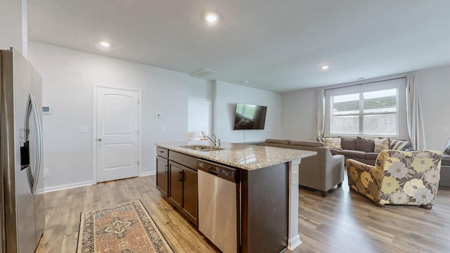 615 Pine Bloom Rd, Lebanon, TN 37087 - kitchen featuring dark brown cabinets, a sink, light wood-type flooring, light stone countertops, and appliances with stainless steel finishes