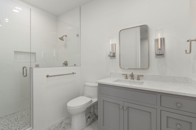 full bathroom with toilet, vanity, a shower stall, and marble finish floor