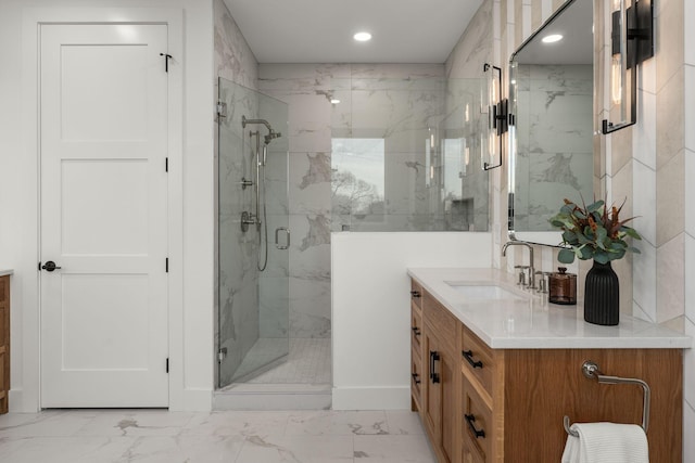 bathroom featuring a marble finish shower, recessed lighting, marble finish floor, and vanity