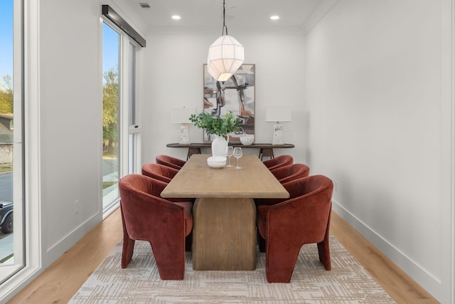 dining room with ornamental molding, recessed lighting, baseboards, and light wood-style floors