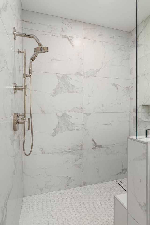 full bathroom featuring a marble finish shower