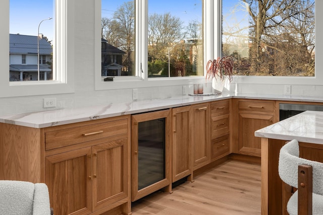 interior space featuring beverage cooler and light wood-style floors