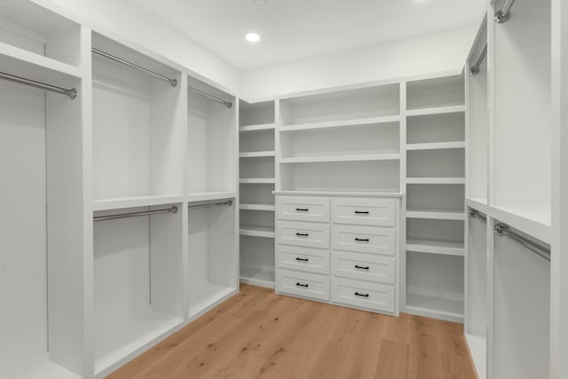 walk in closet with light wood-style flooring
