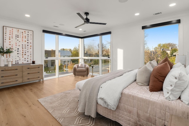bedroom with recessed lighting, ornamental molding, light wood finished floors, visible vents, and a ceiling fan