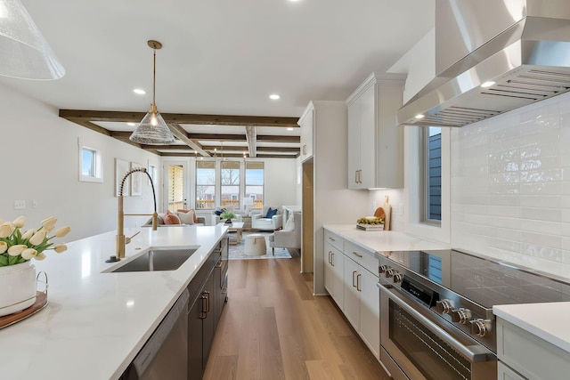 620 Waco Dr Unit B, Nashville, TN 37209 - kitchen with wall chimney range hood, a sink, appliances with stainless steel finishes, open floor plan, and recessed lighting