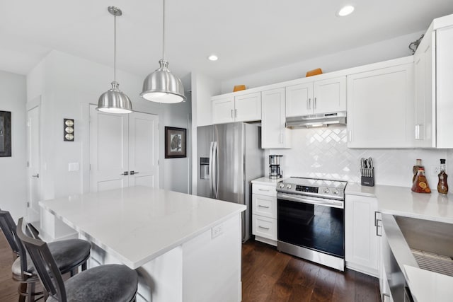 kitchen featuring recessed lighting, appliances with stainless steel finishes, under cabinet range hood, and light countertops