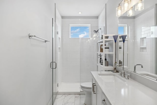 bathroom featuring a stall shower, a wealth of natural light, toilet, and vanity