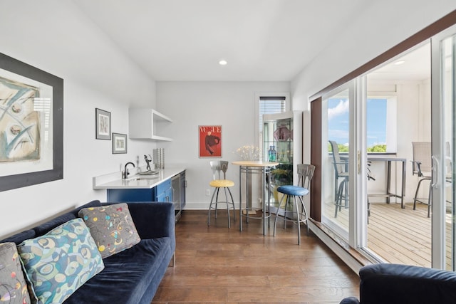 living room featuring baseboards, recessed lighting, and wood-type flooring