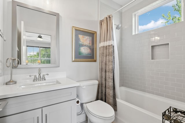 full bathroom featuring toilet, shower / bathtub combination with curtain, ceiling fan, and vanity
