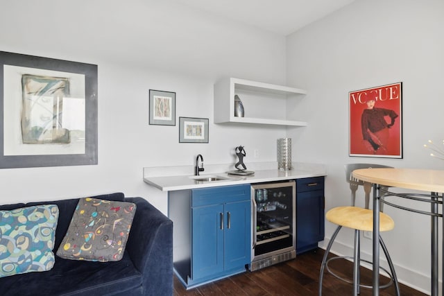bar featuring dark wood-type flooring, a sink, indoor wet bar, and wine cooler