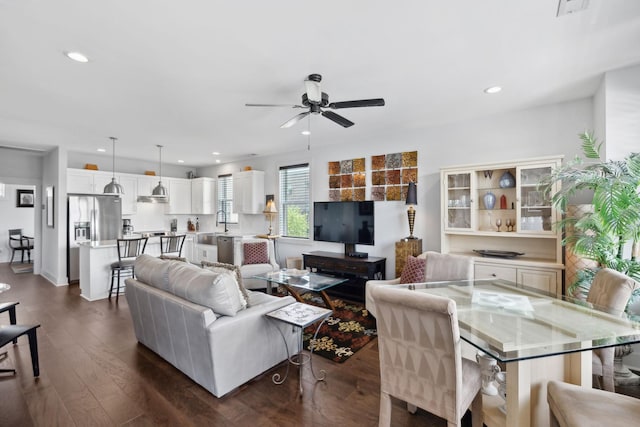 living room with recessed lighting, ceiling fan, and dark wood-style flooring